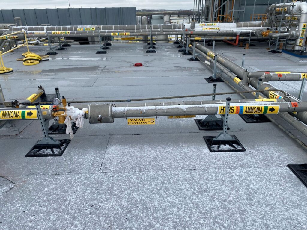 A large metal pipe sitting on top of concrete.