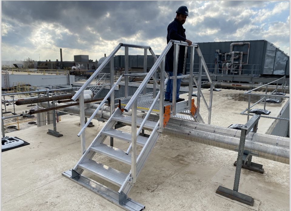A man standing on top of stairs near water.