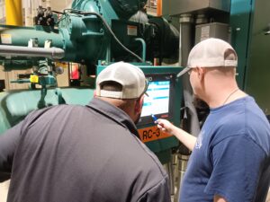 Two men looking at a computer screen.