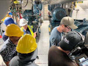 A group of people in hard hats and safety vests.