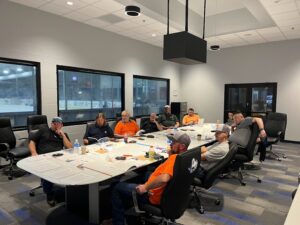 A group of people sitting around a table.