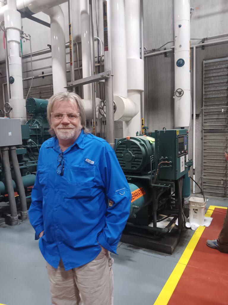 A man standing in front of some industrial equipment.
