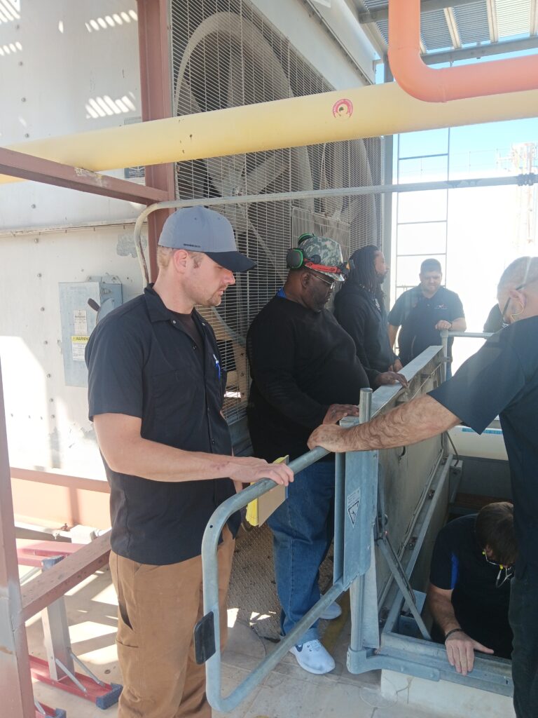 A man in black shirt holding onto a cart.