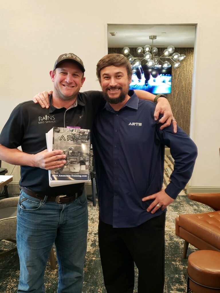 Two men standing next to each other in a room.