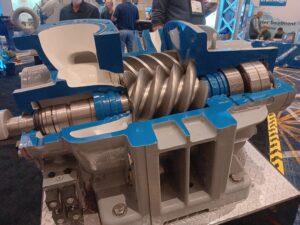 A close up of an engine with people in the background