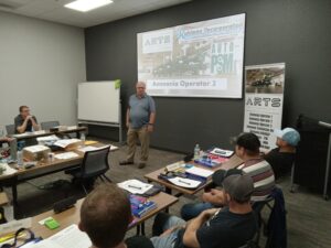 A man standing in front of a class room