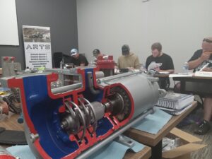 A group of people working on an engine.