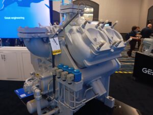 A large machine with many blue bottles on top of it.