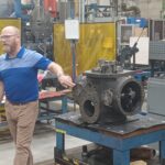 A man standing in front of a machine.