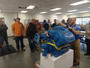 A group of people standing around a machine.