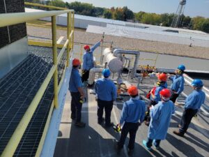 A group of people standing around on top of a building.