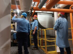 A group of people in hard hats and safety vests.